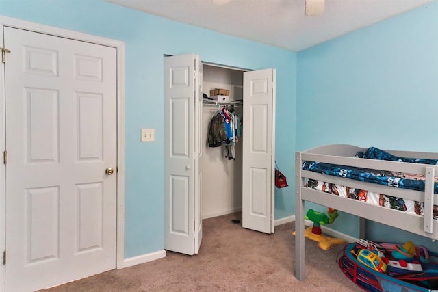 carpeted bedroom with a closet and ceiling fan