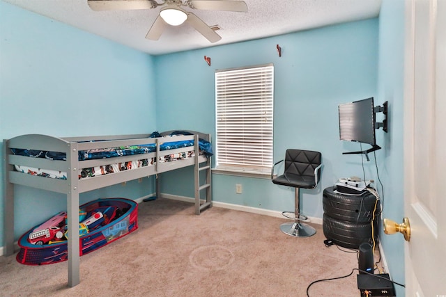 carpeted bedroom featuring multiple windows, a textured ceiling, and ceiling fan