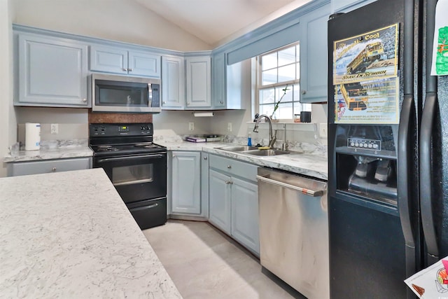 kitchen with sink, lofted ceiling, and black appliances