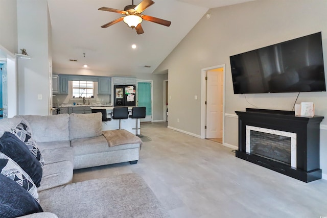 living room with ceiling fan, sink, and high vaulted ceiling