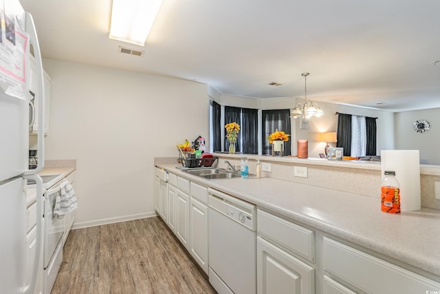 kitchen with white cabinets, hanging light fixtures, light hardwood / wood-style floors, a notable chandelier, and white appliances