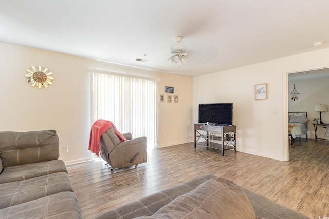 living room featuring hardwood / wood-style floors and ceiling fan