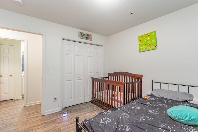 bedroom featuring light hardwood / wood-style flooring and a closet