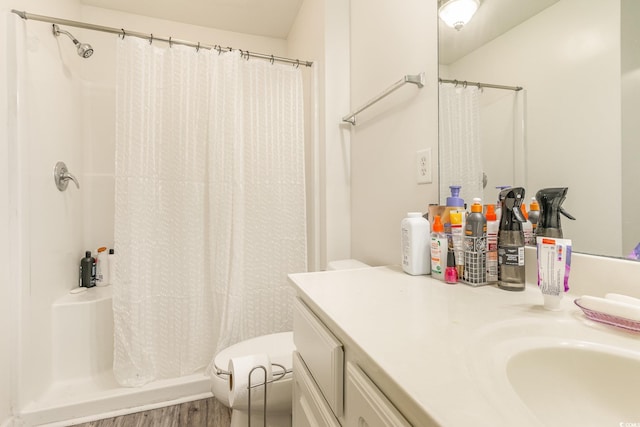 bathroom with vanity, toilet, wood-type flooring, and curtained shower