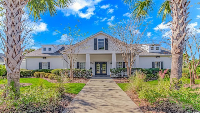 view of front facade featuring french doors and a front lawn