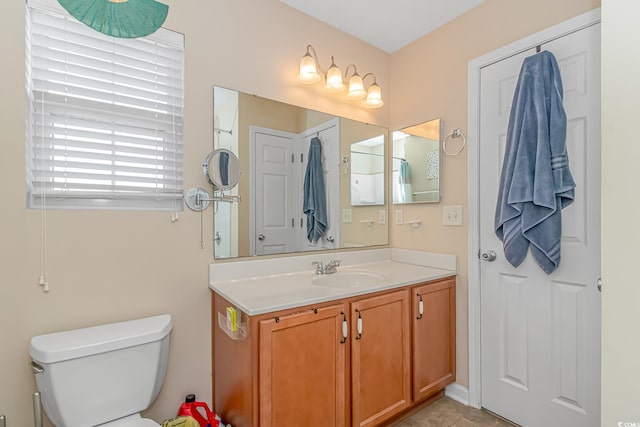 bathroom featuring vanity, toilet, and tile patterned flooring