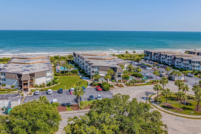 drone / aerial view with a water view and a beach view