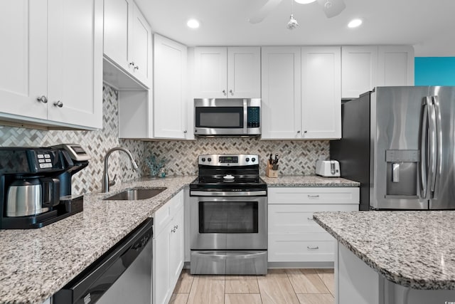 5601 N Ocean Blvd Unit C-202, Myrtle Beach, SC 29577 - kitchen with stainless steel appliances, a sink, backsplash, white cabinetry, and recessed lighting