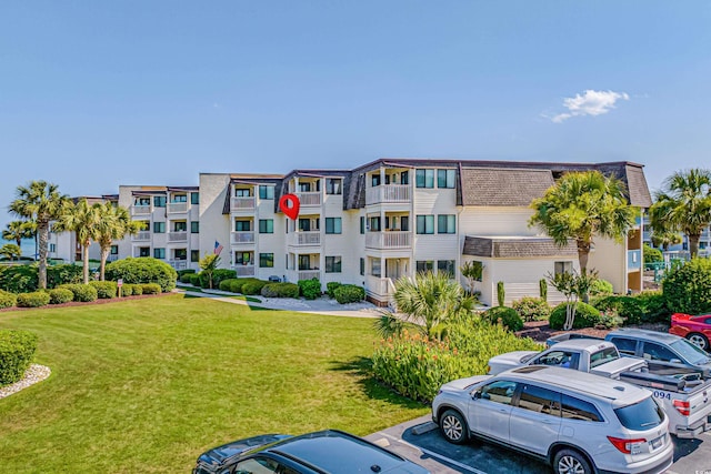 5601 N Ocean Blvd Unit C-202, Myrtle Beach, SC 29577 - view of apartment building / complex featuring uncovered parking