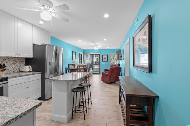 5601 N Ocean Blvd Unit C-202, Myrtle Beach, SC 29577 - kitchen with a ceiling fan, stainless steel appliances, a breakfast bar, healthy amount of natural light, and recessed lighting