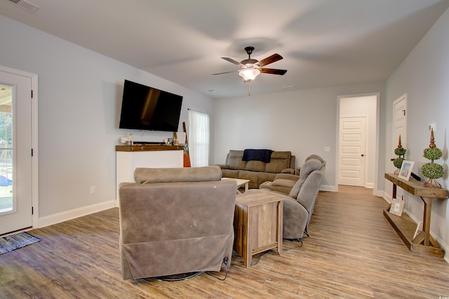 living room with ceiling fan and hardwood / wood-style floors