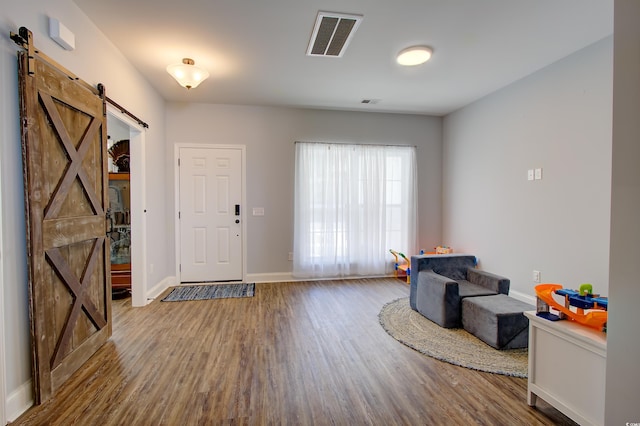 entryway featuring a barn door and hardwood / wood-style floors