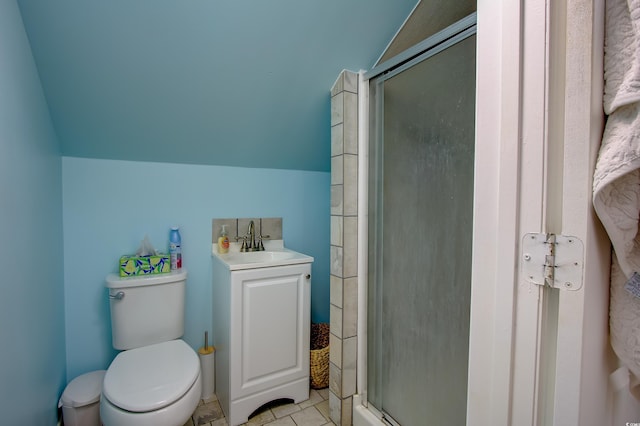 bathroom with tile patterned floors, an enclosed shower, lofted ceiling, toilet, and vanity