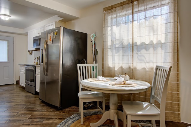 kitchen with white cabinets and appliances with stainless steel finishes