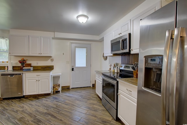 kitchen featuring white cabinetry and appliances with stainless steel finishes