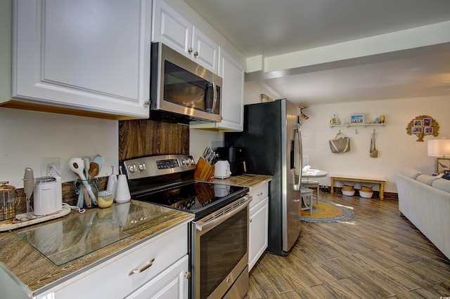 kitchen featuring white cabinets, wood-type flooring, and stainless steel appliances