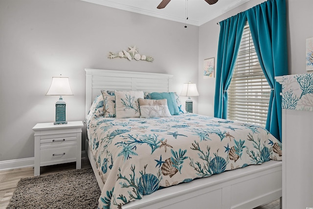 bedroom featuring ornamental molding, light hardwood / wood-style floors, and ceiling fan