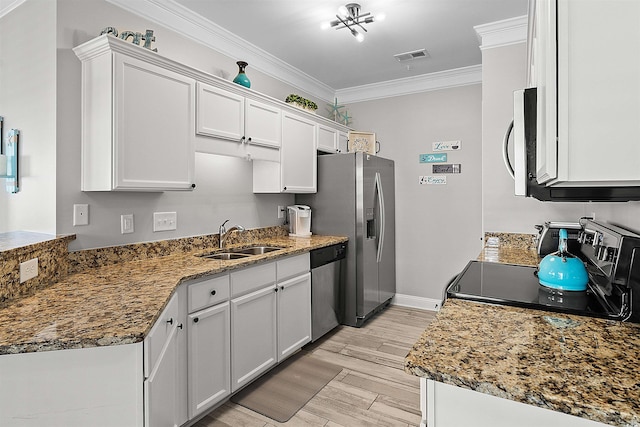 kitchen with stainless steel appliances, sink, crown molding, white cabinets, and light wood-type flooring