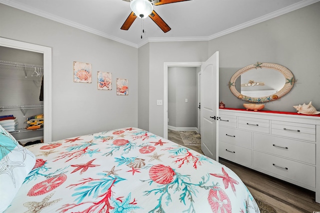 bedroom with dark hardwood / wood-style flooring, a closet, ceiling fan, and ornamental molding