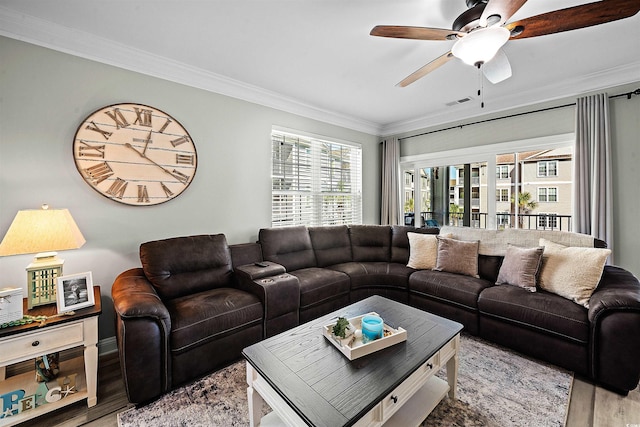 living room with ceiling fan, hardwood / wood-style flooring, a healthy amount of sunlight, and crown molding