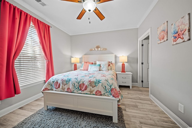 bedroom with ceiling fan, light hardwood / wood-style floors, and crown molding