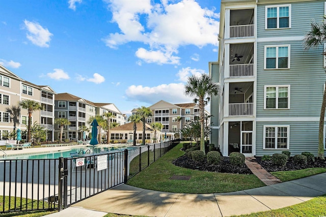 surrounding community with a lawn and a pool