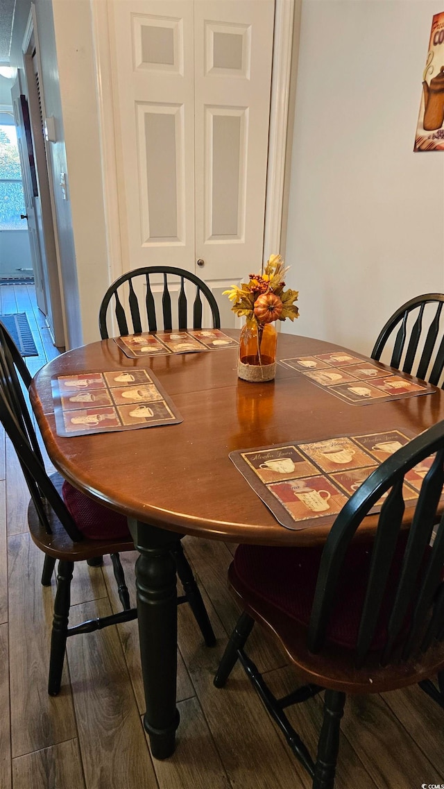 dining space with dark hardwood / wood-style flooring