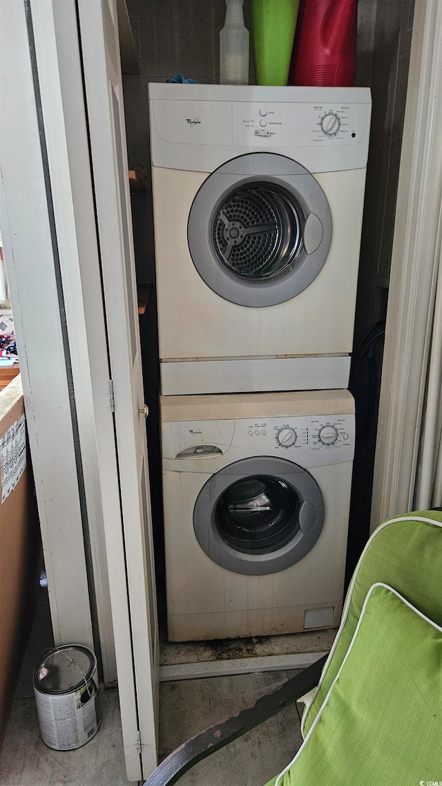 laundry room with stacked washer / dryer