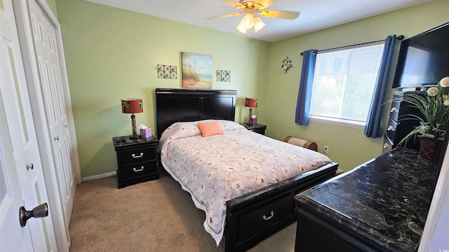 carpeted bedroom with a closet and ceiling fan