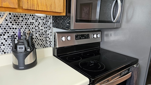 kitchen with backsplash and stainless steel appliances