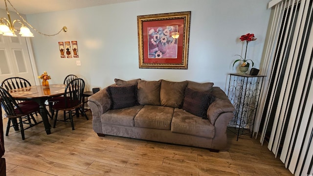 living room featuring light hardwood / wood-style flooring and an inviting chandelier