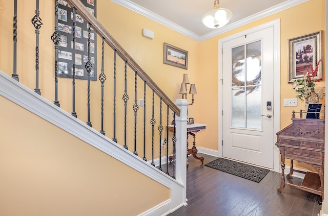 foyer entrance with ornamental molding and dark wood-type flooring