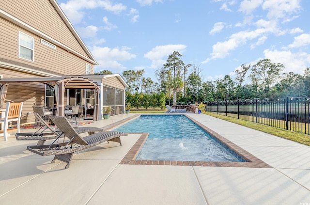 view of swimming pool featuring a sunroom and a patio area