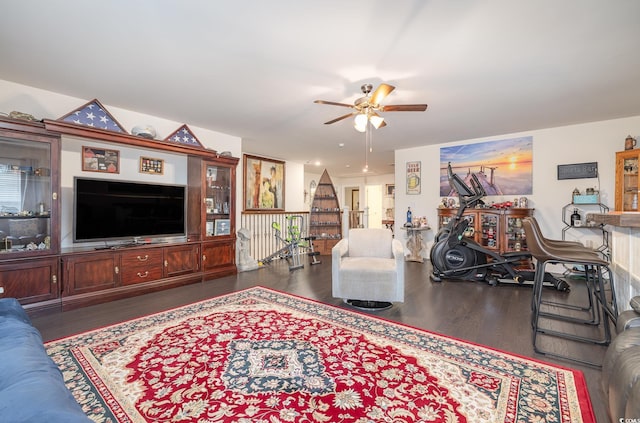 living room with ceiling fan and dark hardwood / wood-style flooring