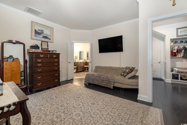 bedroom with connected bathroom, dark wood-type flooring, and crown molding