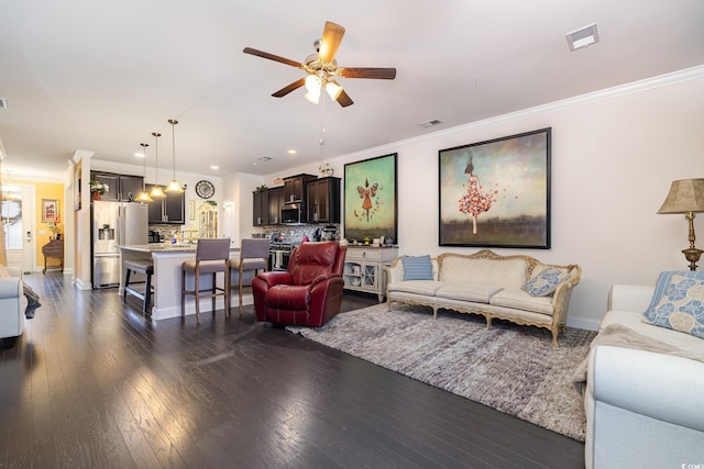 living room featuring ornamental molding, ceiling fan, and dark hardwood / wood-style flooring