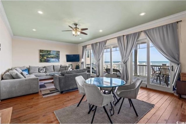 dining room featuring crown molding, wood-type flooring, and ceiling fan