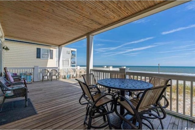 deck featuring a water view and a beach view