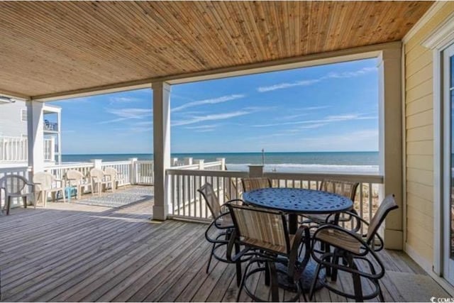 wooden terrace with a water view and a beach view