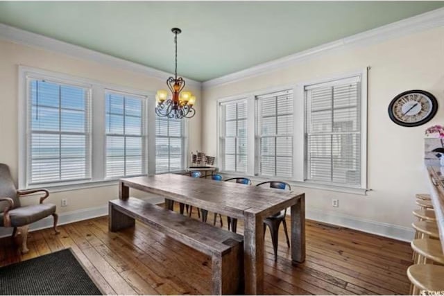 dining space featuring a notable chandelier, hardwood / wood-style flooring, and ornamental molding