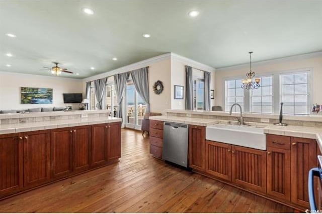 kitchen featuring pendant lighting, dishwasher, dark hardwood / wood-style floors, and a healthy amount of sunlight