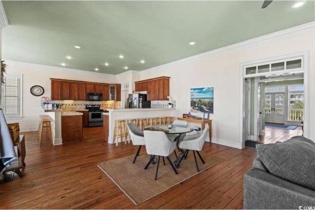 dining room featuring ornamental molding and dark wood-type flooring