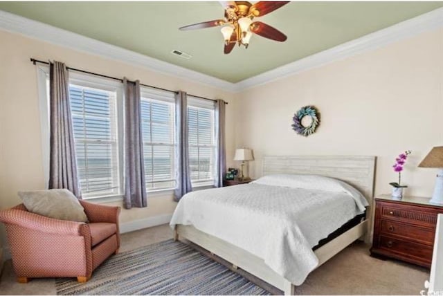 carpeted bedroom featuring crown molding and ceiling fan