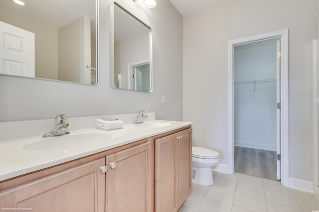 bathroom featuring vanity, toilet, and tile patterned floors