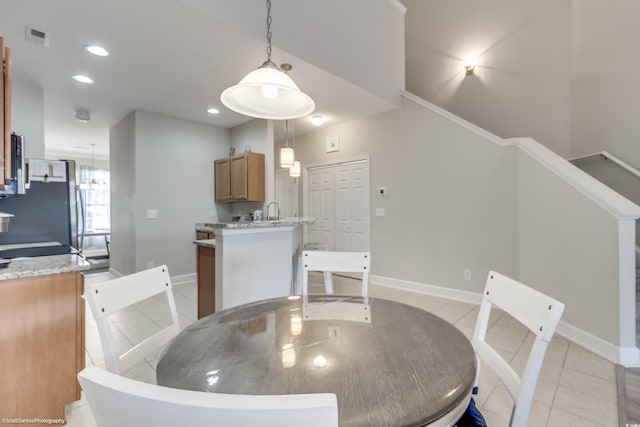 tiled dining room featuring sink