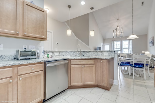 kitchen featuring pendant lighting, light brown cabinetry, sink, and stainless steel dishwasher