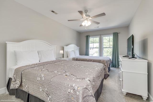 bedroom featuring ceiling fan and light carpet