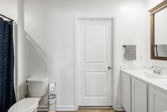 bathroom featuring hardwood / wood-style floors, vanity, and toilet