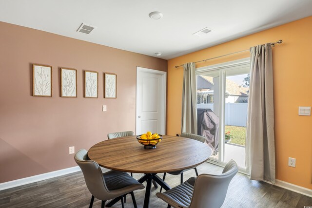 dining space featuring dark hardwood / wood-style floors