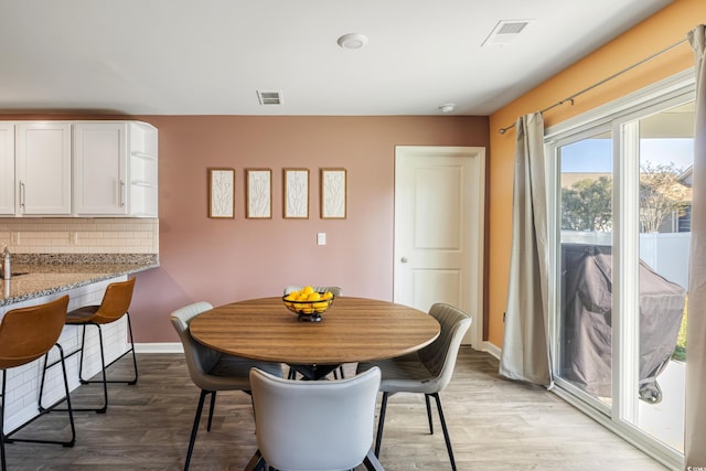 dining space with light hardwood / wood-style floors